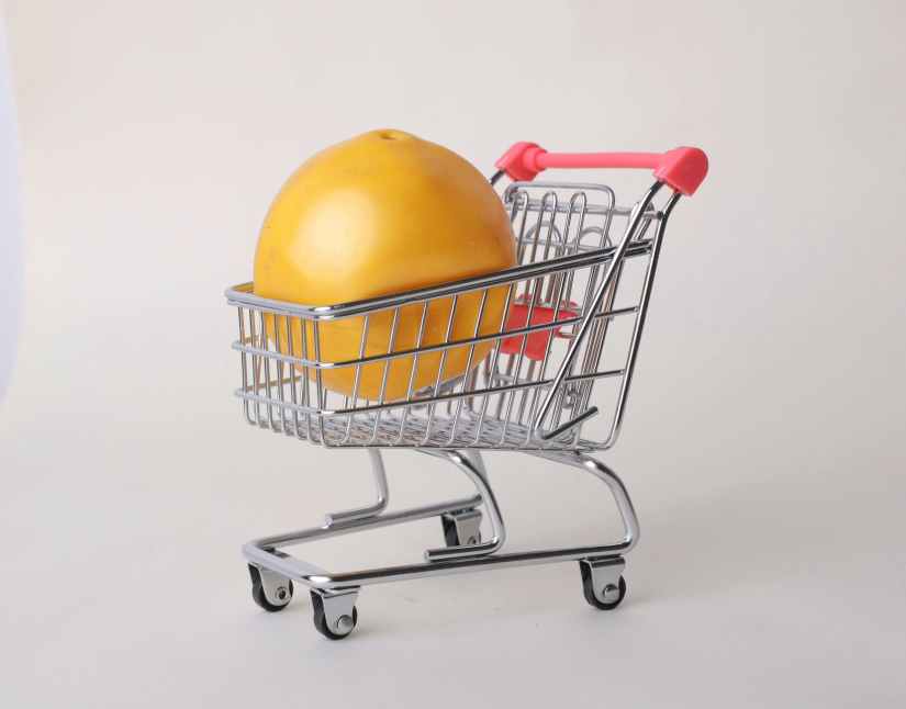 orange in a mini shopping cart