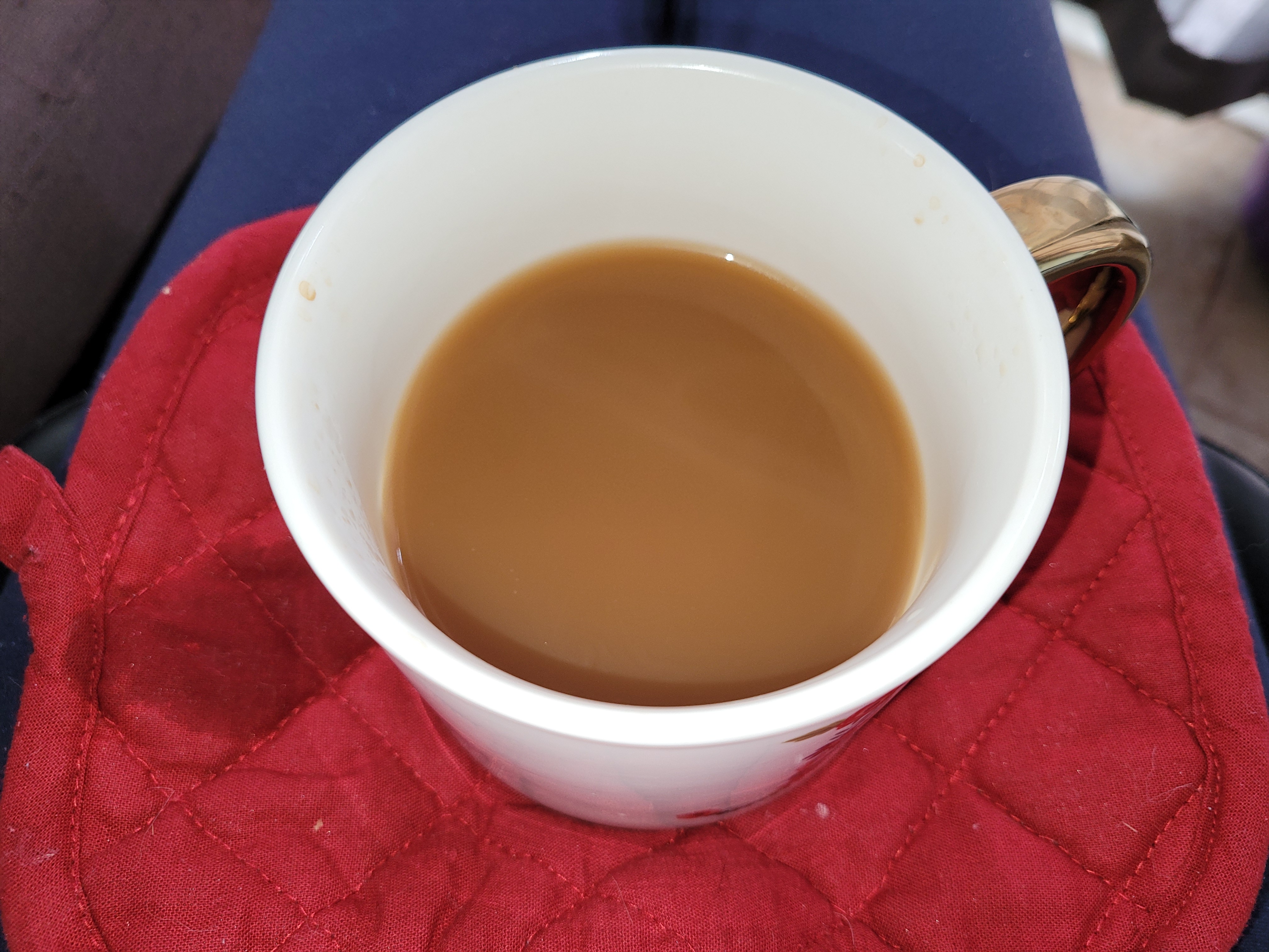 Cup of coffee on hot pad.