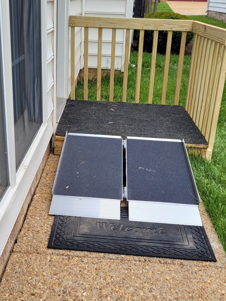 platform with railings and a suitcase ramp.