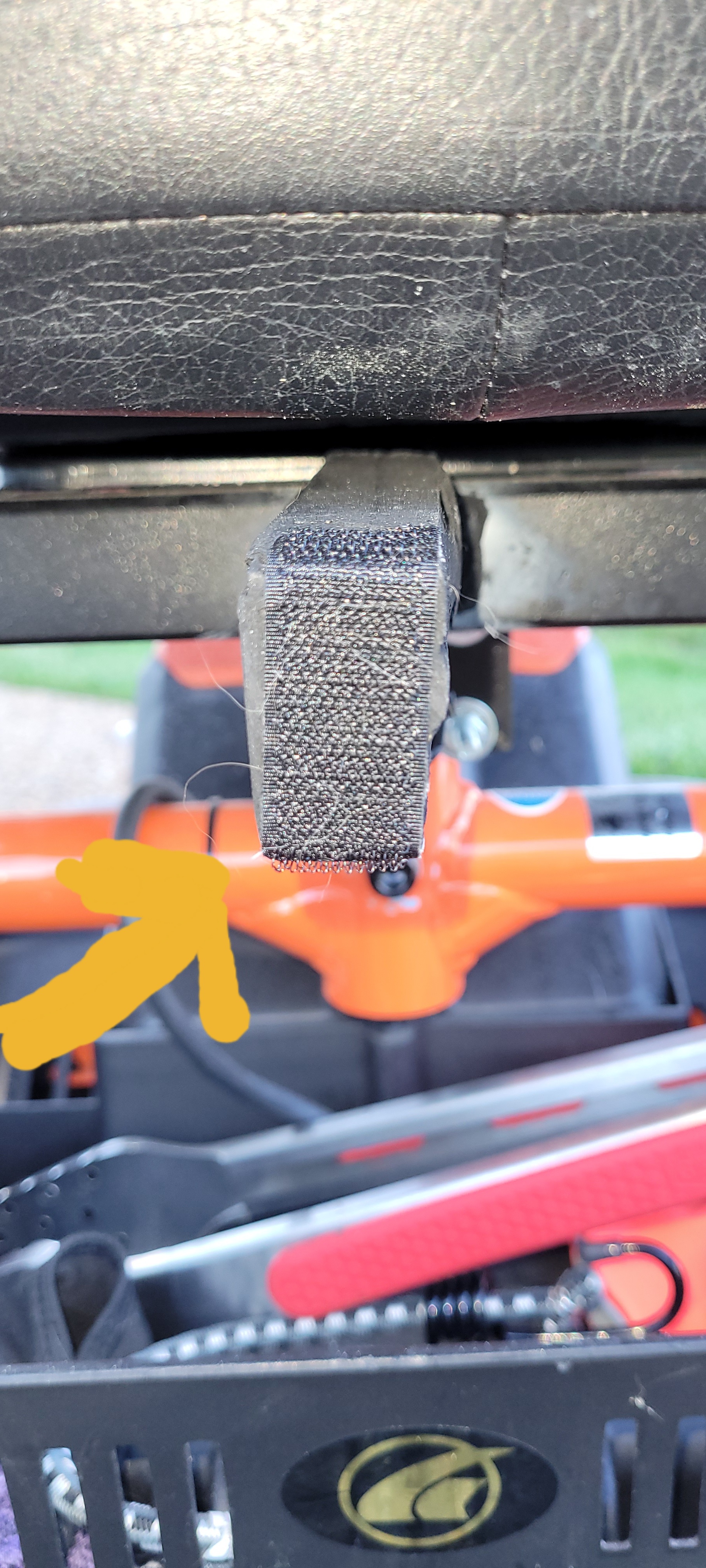 Wood post painted black with a velcro strip attached. The post is glued to power chair post.